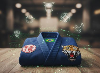 A folded blue BJJ Gi featuring a prominent patch with national symbols or cultural motifs